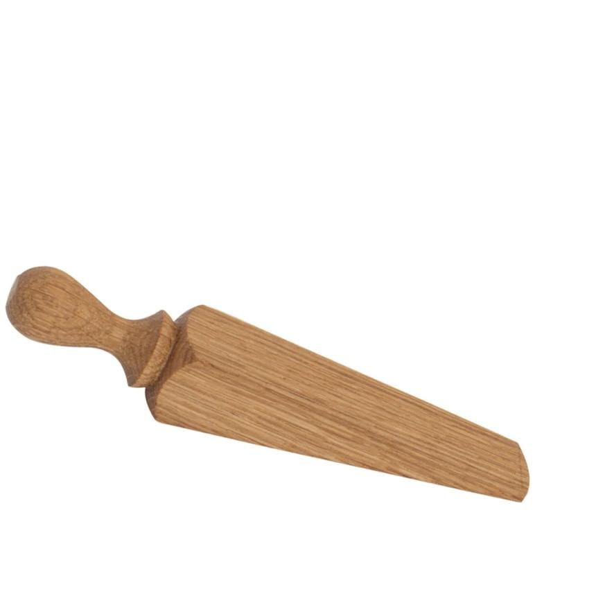 Product Description: The OAK DOOR STOP by Redecker is a hand-crafted wooden doorstop featuring an angled wedge shape with a convenient small handle on one end. Its stylish oak grain adds a natural touch that enhances any space.