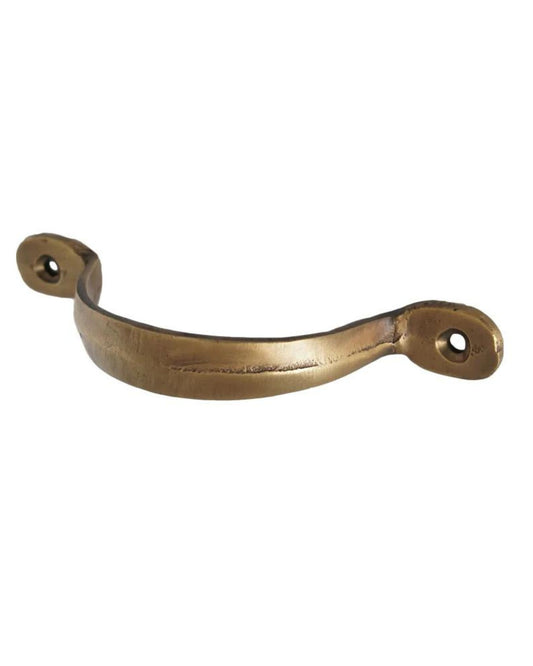 The TRICORN DRAWER PULL by Society Ink is a bronze-colored metal handle featuring a curved shape and two screw holes on either end, ideal for seamlessly integrating into captain cabinetry.