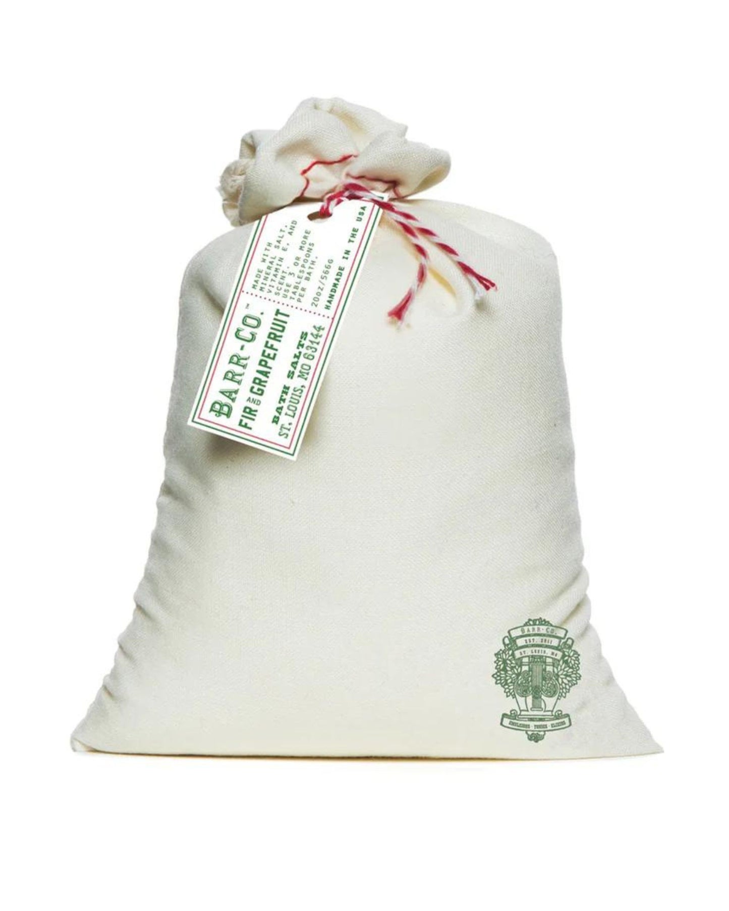 A luxurious bag of Barr Co bath salts features a white cloth design with a drawstring closure and is adorned with a green label at the top. The lower right side bears a green emblem, while the attached label reads "Barr-Co. Fir Grapefruit," highlighting its plant-based ingredients.