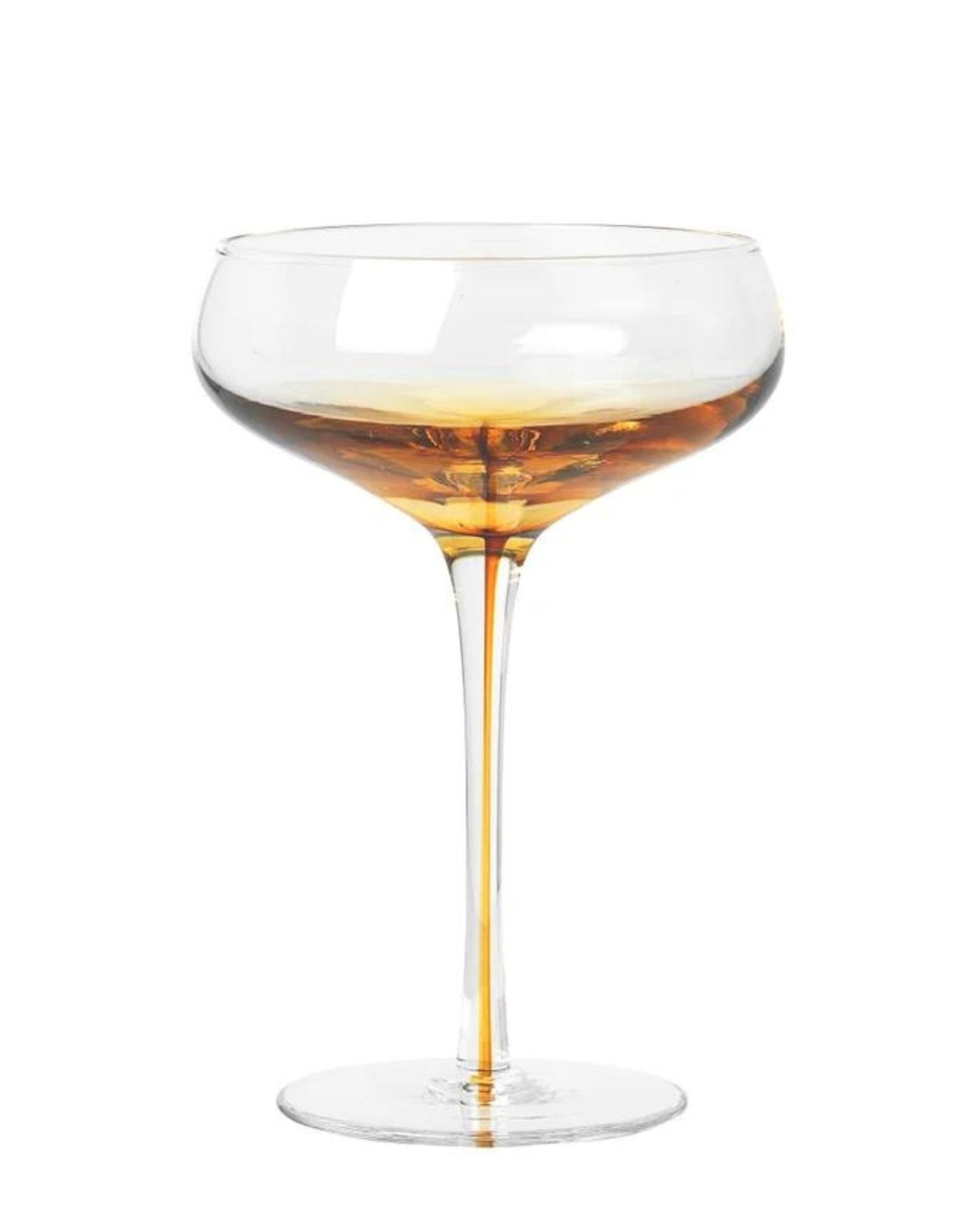 A Broste COCKTAIL GLASS from the Amber collection features a golden liquid within its clear coupe design. The elegant stem and wide, shallow bowl create a classic silhouette, inspired by Nordic nature, with the liquid catching the light and casting subtle reflections.