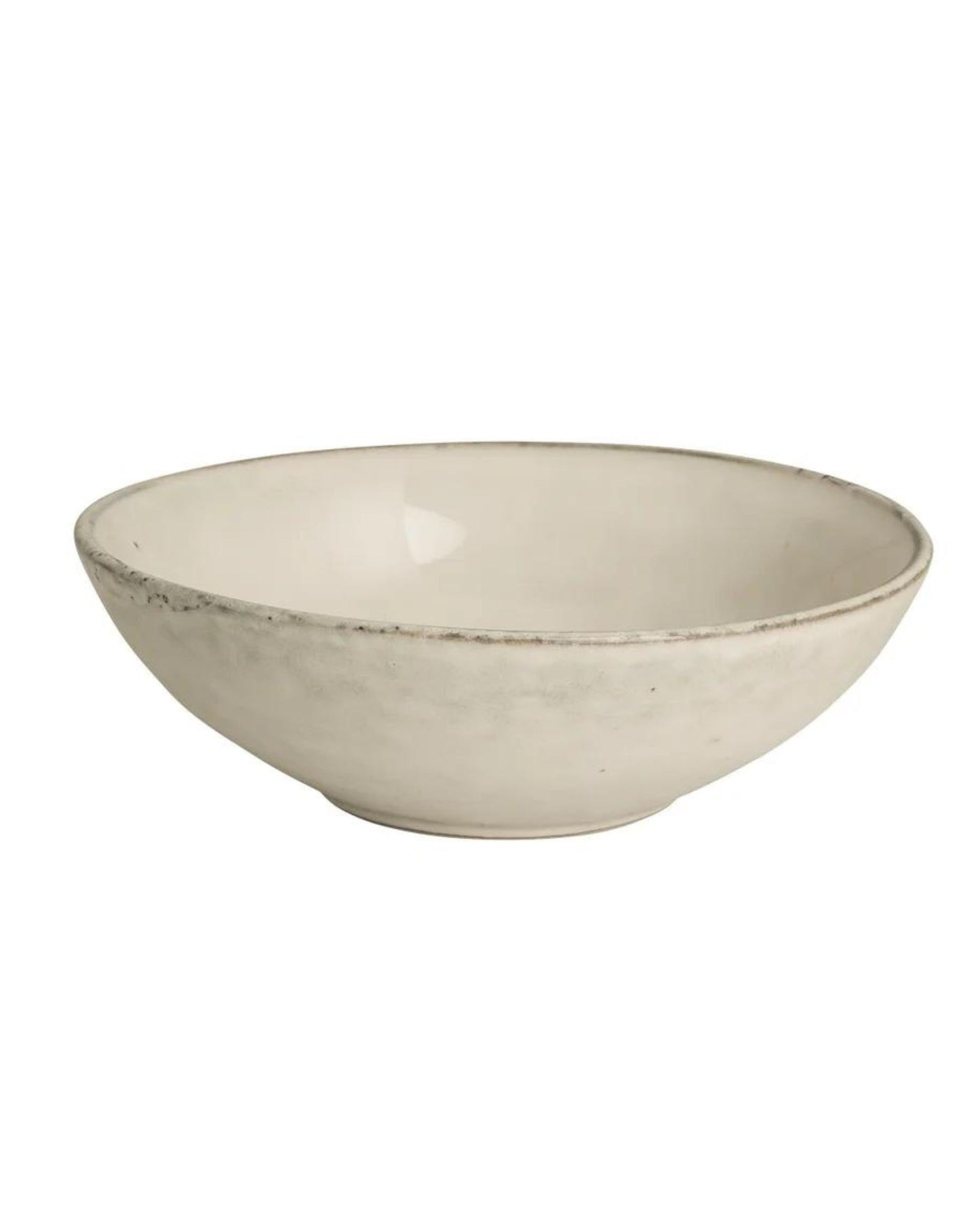 The Broste NORDIC SAND PASTA BOWL exudes coastal elegance with its minimalist, shallow design, slightly uneven edge, and matte Nordic Sand finish, beautifully showcased against a plain white backdrop.