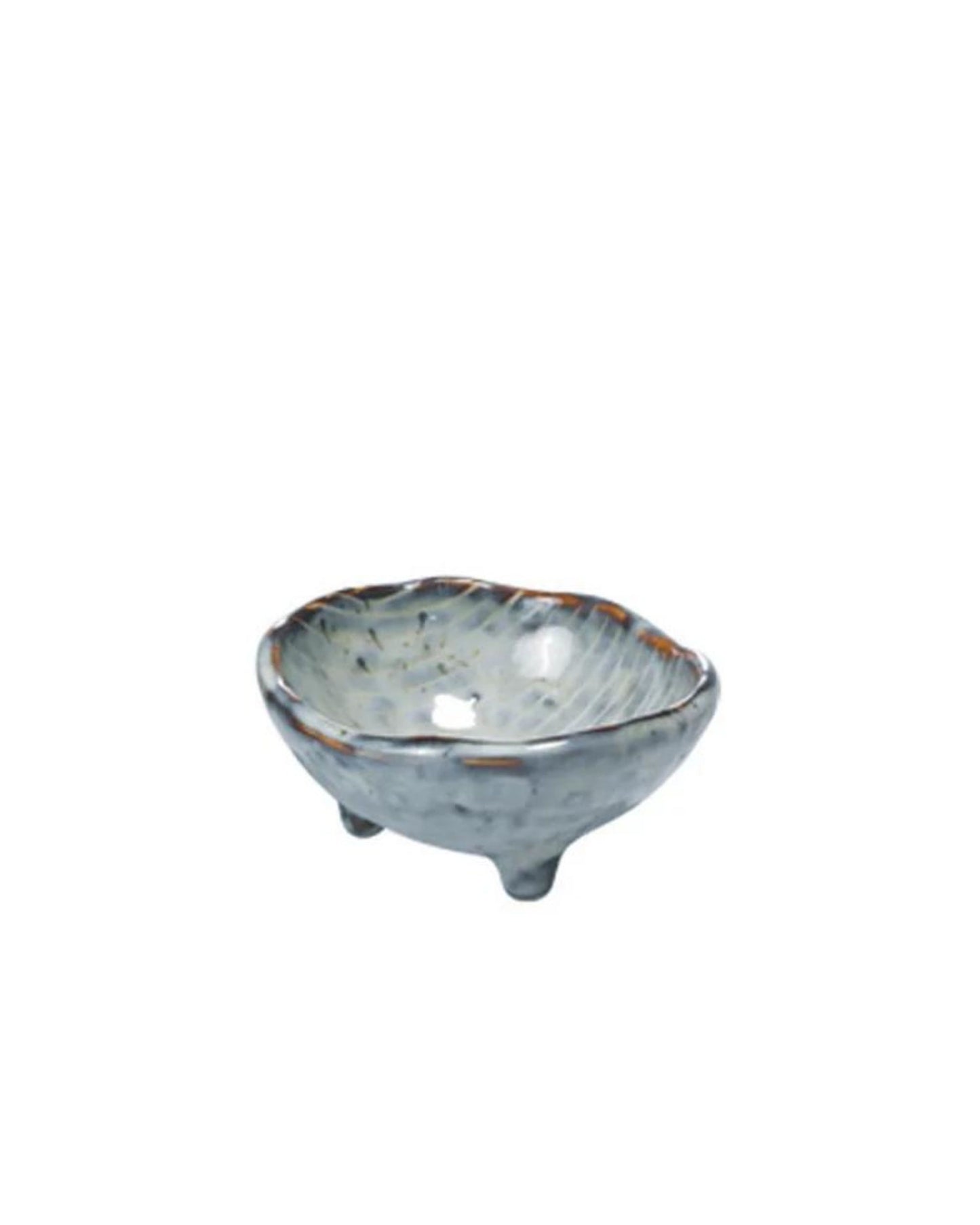 The SMALL BOWL W/FEET by Broste is a chic, blue-gray ceramic bowl featuring a textured exterior and three short legs. Its design includes subtle speckles and a slightly uneven rim, creating an artisanal and decorative appearance.