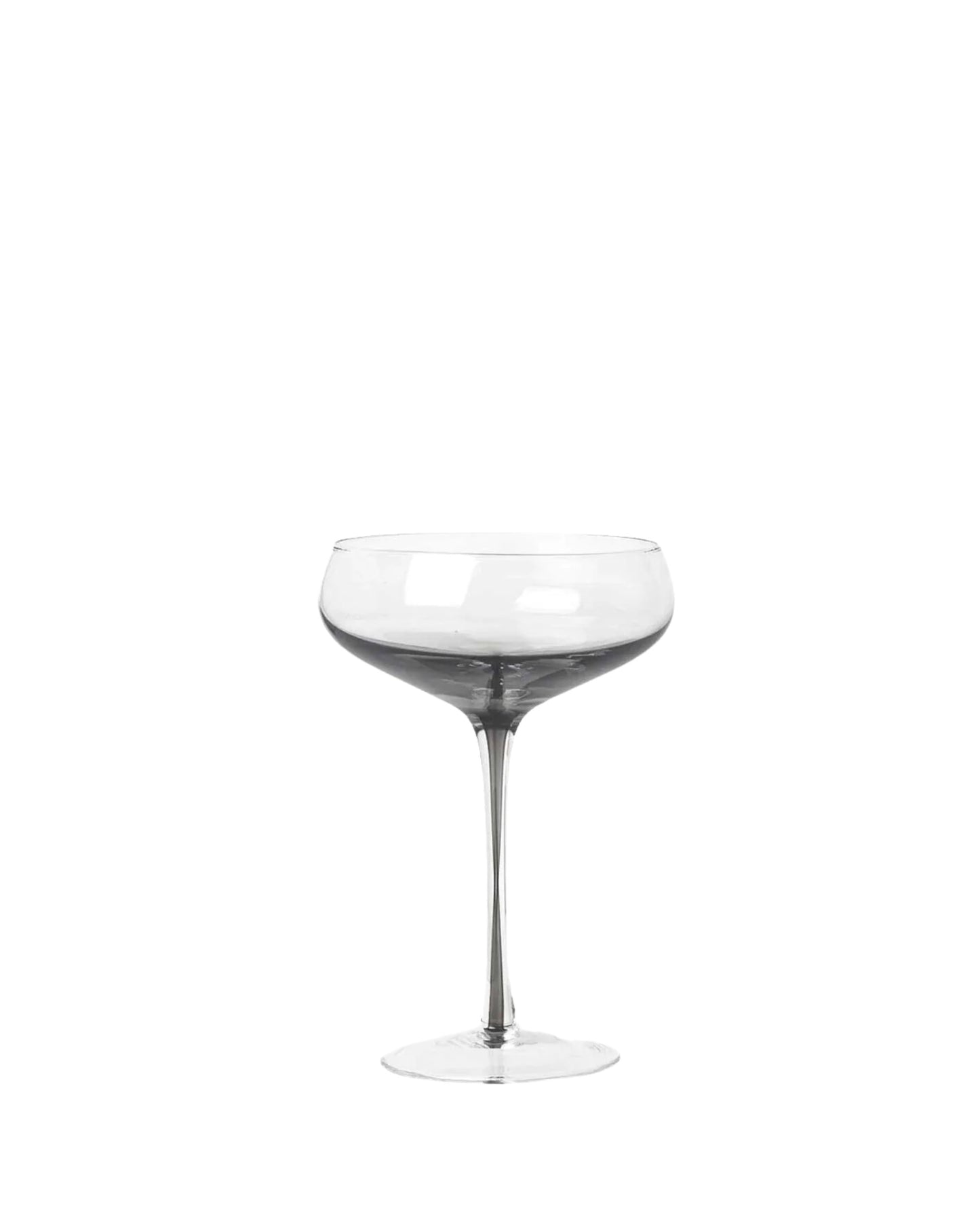 A clear, empty COCKTAIL GLASS from Broste, featuring a round bowl and a slender stem, is set against a plain white background. This piece, part of the Amber collection, is handmade with a smooth and elegant design that emphasizes its transparency and simplicity.