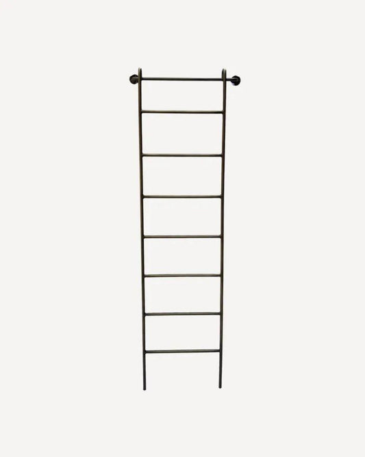 The METAL WALL LADDER by French Country is a tall, bronze wall ladder featuring seven evenly spaced rungs against a plain white background. Designed for indoor use, it is supported at the top by two pegs and fits perfectly in a hallway or bedroom.