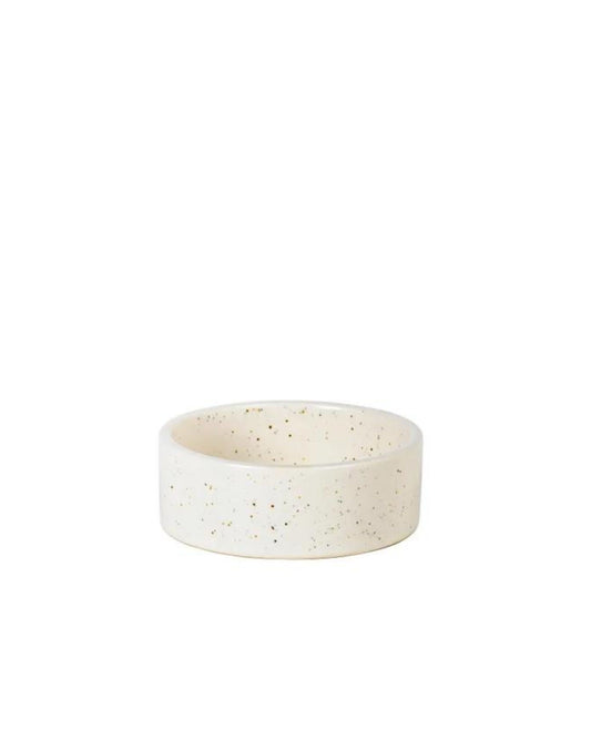 A Broste Nordic Vanilla Mini Round Bowl, featuring a speckled design on white ceramic, sits on a plain white background.