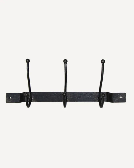 The OLD METAL 3 HOOK BAR by French Country is a black iron wall-mounted coat rack featuring three evenly spaced hooks along a horizontal bar. Each hook has rounded tips, and the bar includes two screw holes at each end for secure mounting. The simple white background emphasizes the rack's sleek design.