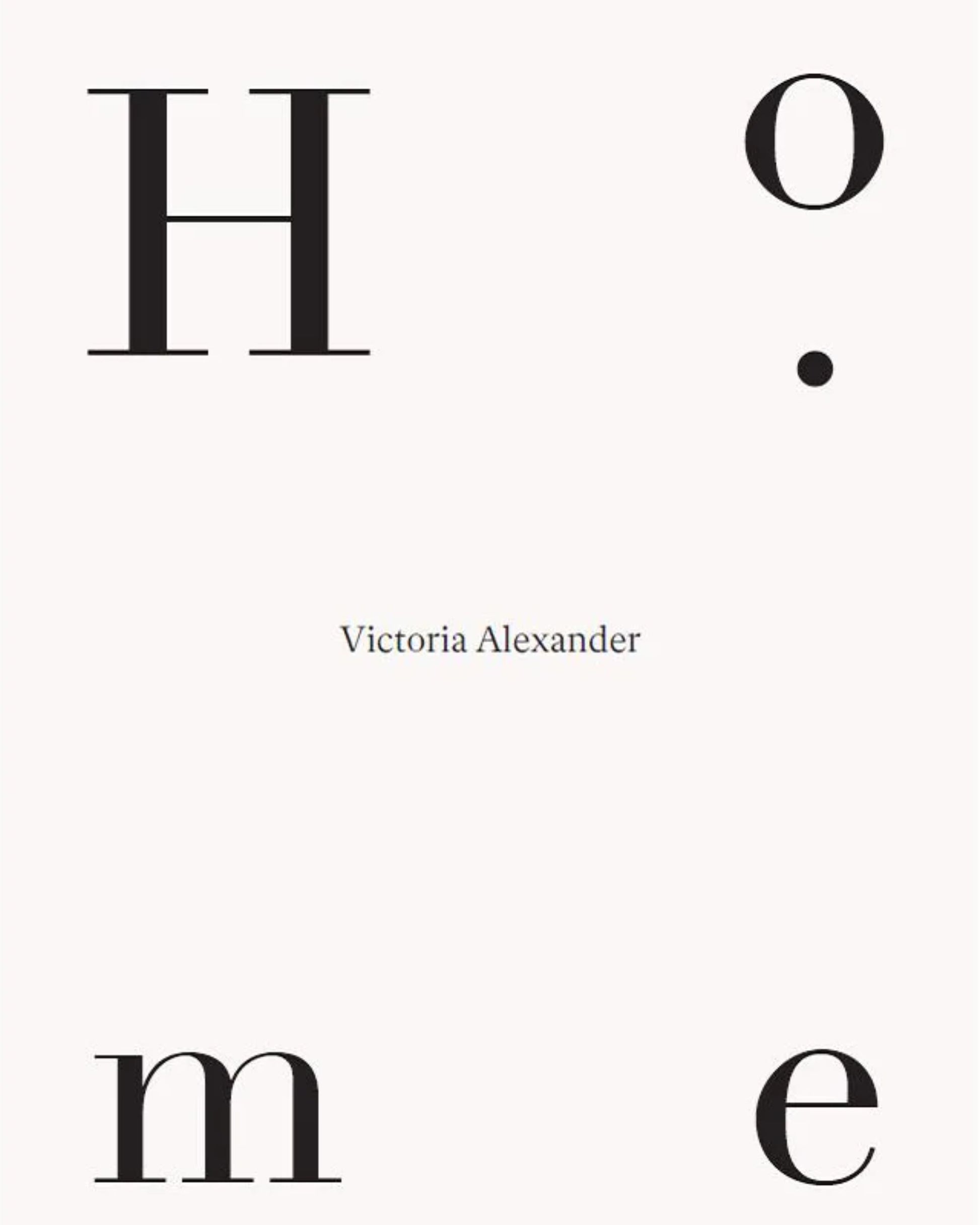 A minimalist book cover for "HOME - VICTORIA ALEXANDER" by Nation Wide Books showcases the word 'Home' with each letter arranged strategically: 'H' in the top left, 'o' in the top right, 'm' in the bottom left, and 'e' in the bottom right. Centered beneath these letters is Victoria Alexander's name in smaller font. The overall design conveys comfort and wellbeing against a serene white background.