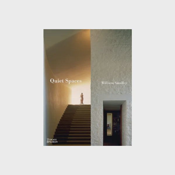 The cover of "QUIET SPACES - WILLIAM SMALLEY," published by Nation Wide Books, elegantly captures interiors for introverts, showcasing a minimalist staircase leading to a softly lit area. A small sculpture adorns the top step, beautifully highlighting tranquility and simplicity.