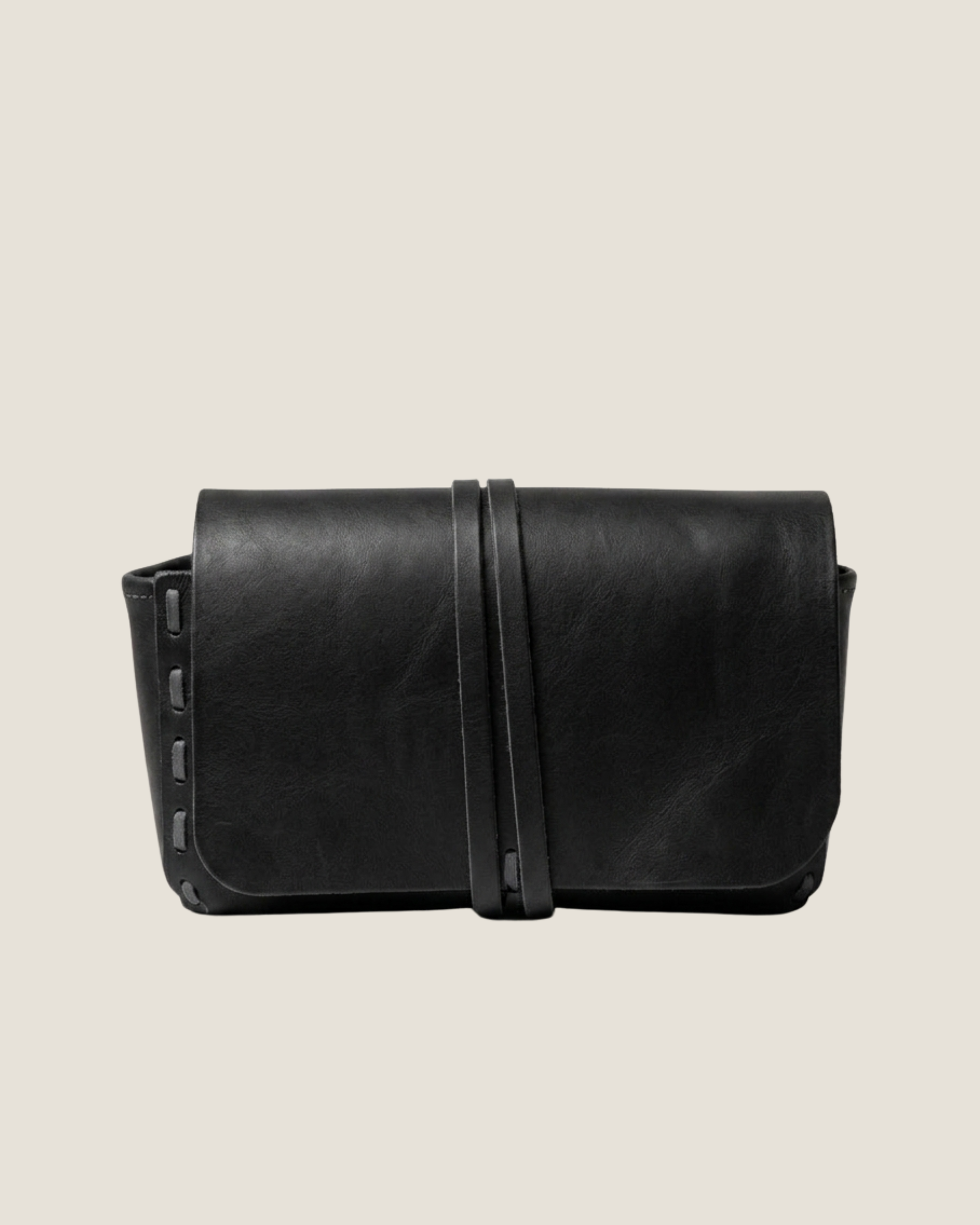 Black leather bag on a light gray background