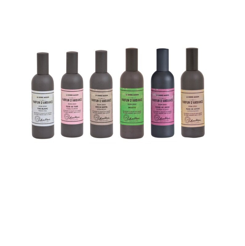 Six LA BONNE MAISON FRENCH ROOM SPRAYS from La Bonne Maison are arranged in a row, each with a uniquely colored label representing different home fragrances. The cylindrical bottles are equipped with convenient spray nozzles for easy use.