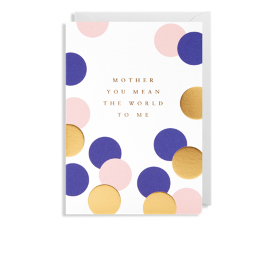 The Ink Bomb greeting card titled "MOTHER YOU MEAN THE WORLD TO ME" showcases the heartfelt message in gold text. It features a design with overlapping circles in pink, blue, and gold against a white background, with an envelope partially visible behind it.