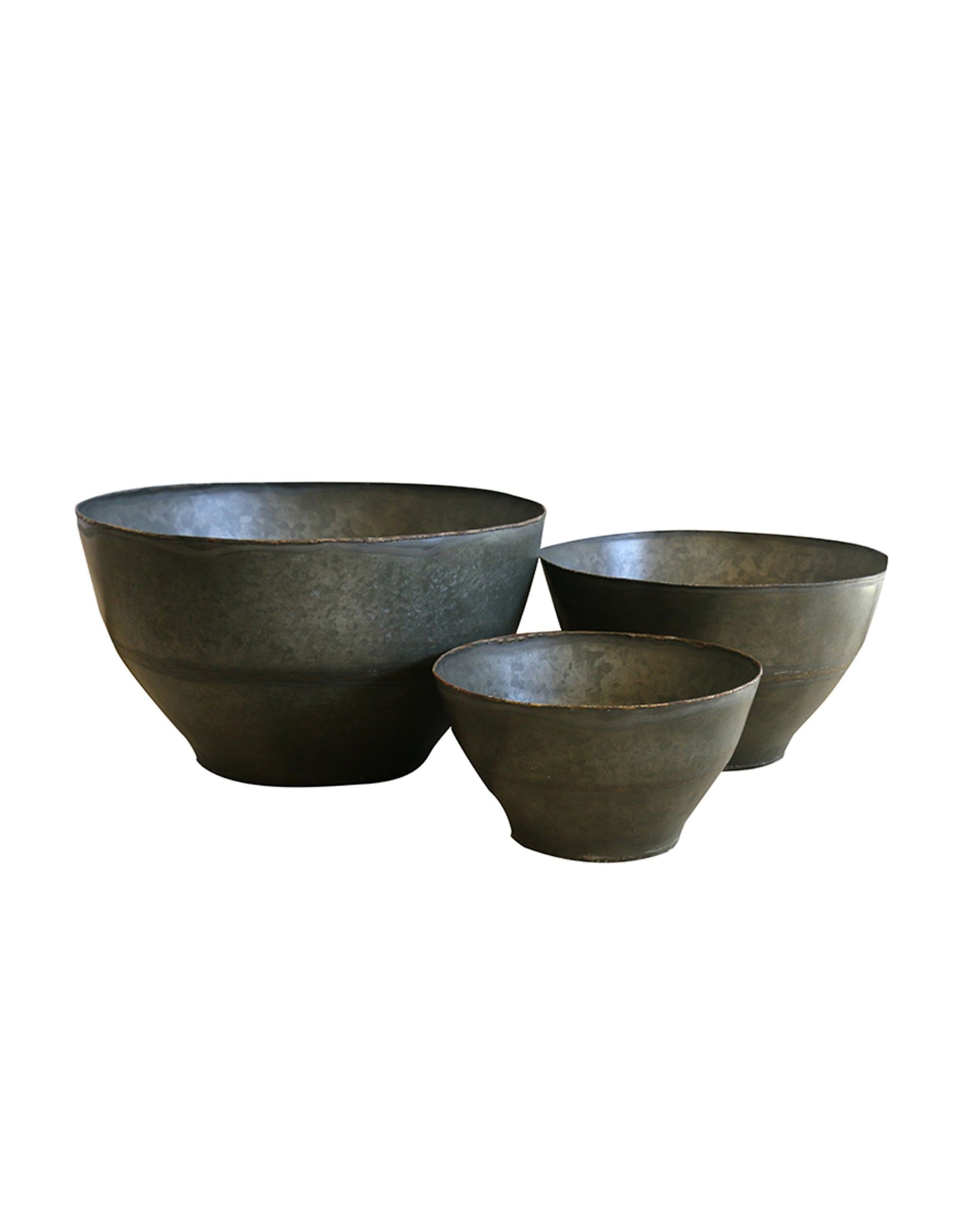 The set includes three dark gray, matte-finish CC Interiors Haveli Planter bowls, elegantly arranged in a graduated size sequence with the largest on the left and the smallest on the right. Their simple, curved design offers a rustic yet refined aesthetic, ideal for enhancing both indoor and outdoor spaces.