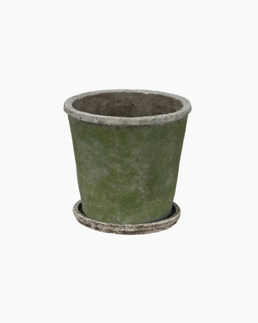 The EVERGREEN PLANT POT & SAUCER by French Country is a green, cylindrical plant pot with a weathered appearance and cement finish, elegantly displayed on a matching saucer against a plain white background.