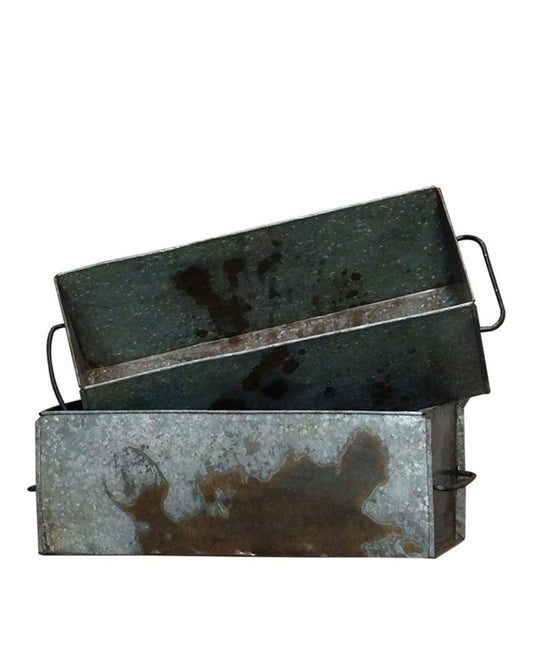 Two FLINT RECTANGLE PLANTER trays by Hawthorne are stacked on top of each other. Crafted from reclaimed metal, these rustic rectangular pieces feature side handles and display visible wear and patina, reminiscent of vintage lavender planters.