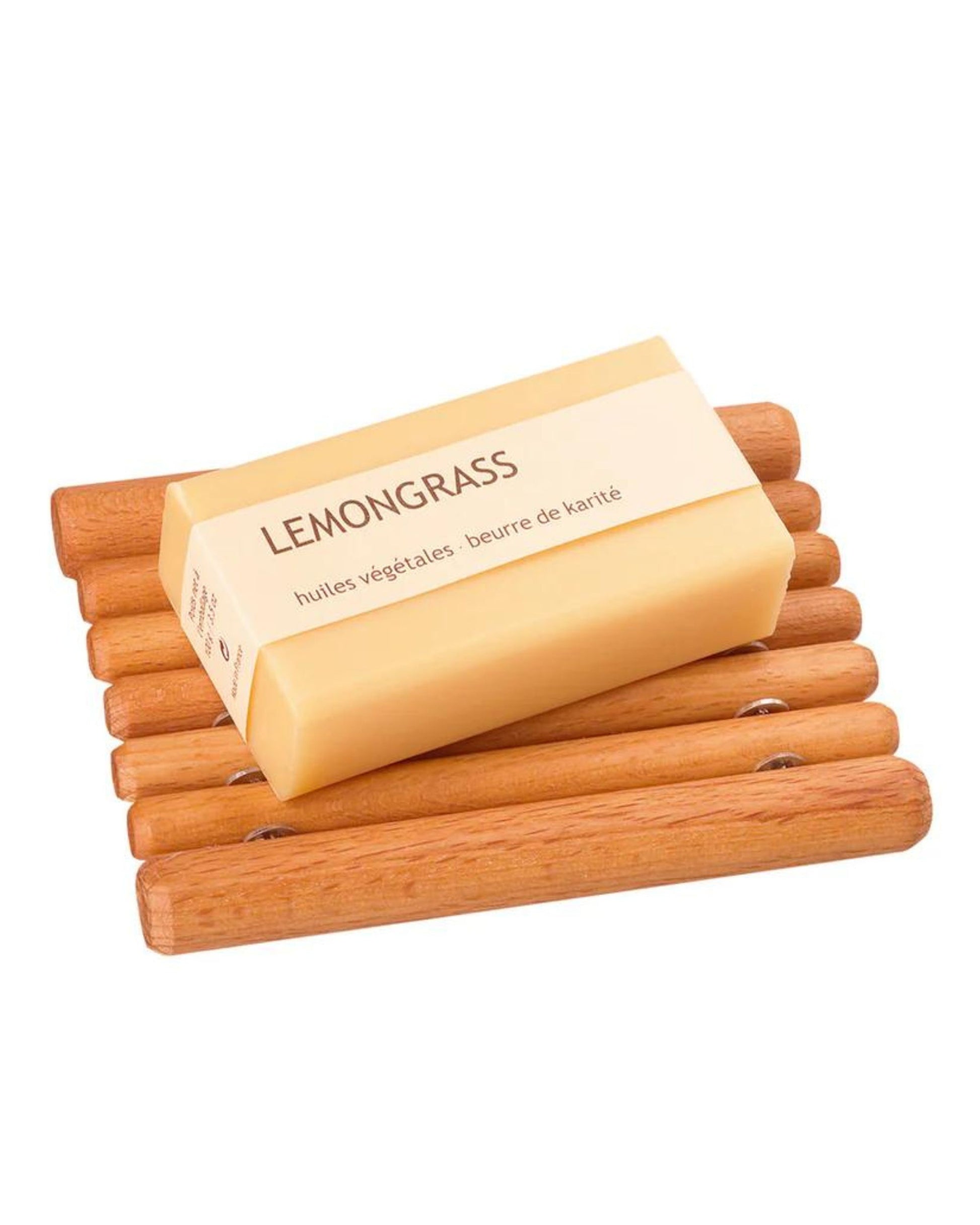 A bar of lemongrass soap rests beautifully on a Redecker BEECH WOOD SOAP DISH, with its packaging emphasizing the use of vegetable oils and shea butter (huiles végétales and beurre de karité). The sustainably sourced dish, featuring parallel wooden rods, offers durability against bathroom moisture.