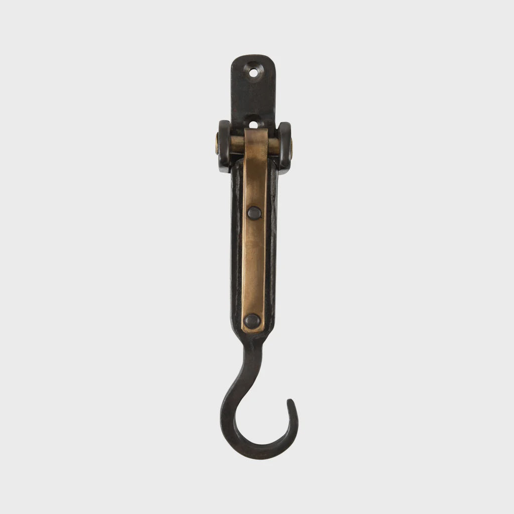 The LARDER HOOK by Society Ink is a vintage metal and brass wall hook with a pivoting bracket, mounted on a plain white background. This special edition piece is designed for hanging items and boasts a classic, industrial look.