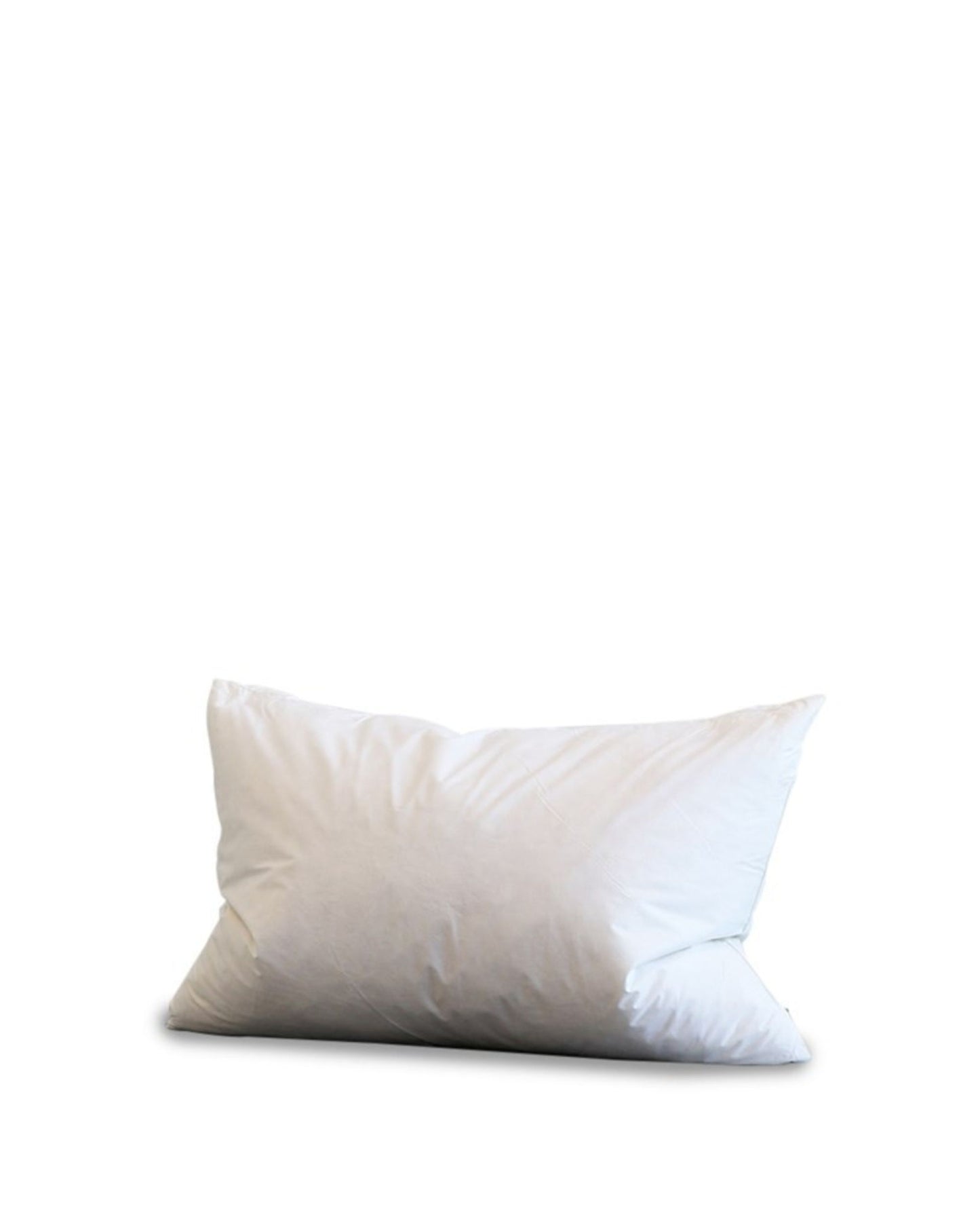 A soft white pillow on a plain white background resembles the plush Hawthorne INNER 45x65 cushion, filled with duck feathers. It appears slightly creased, hinting at a comfortable and inviting texture.