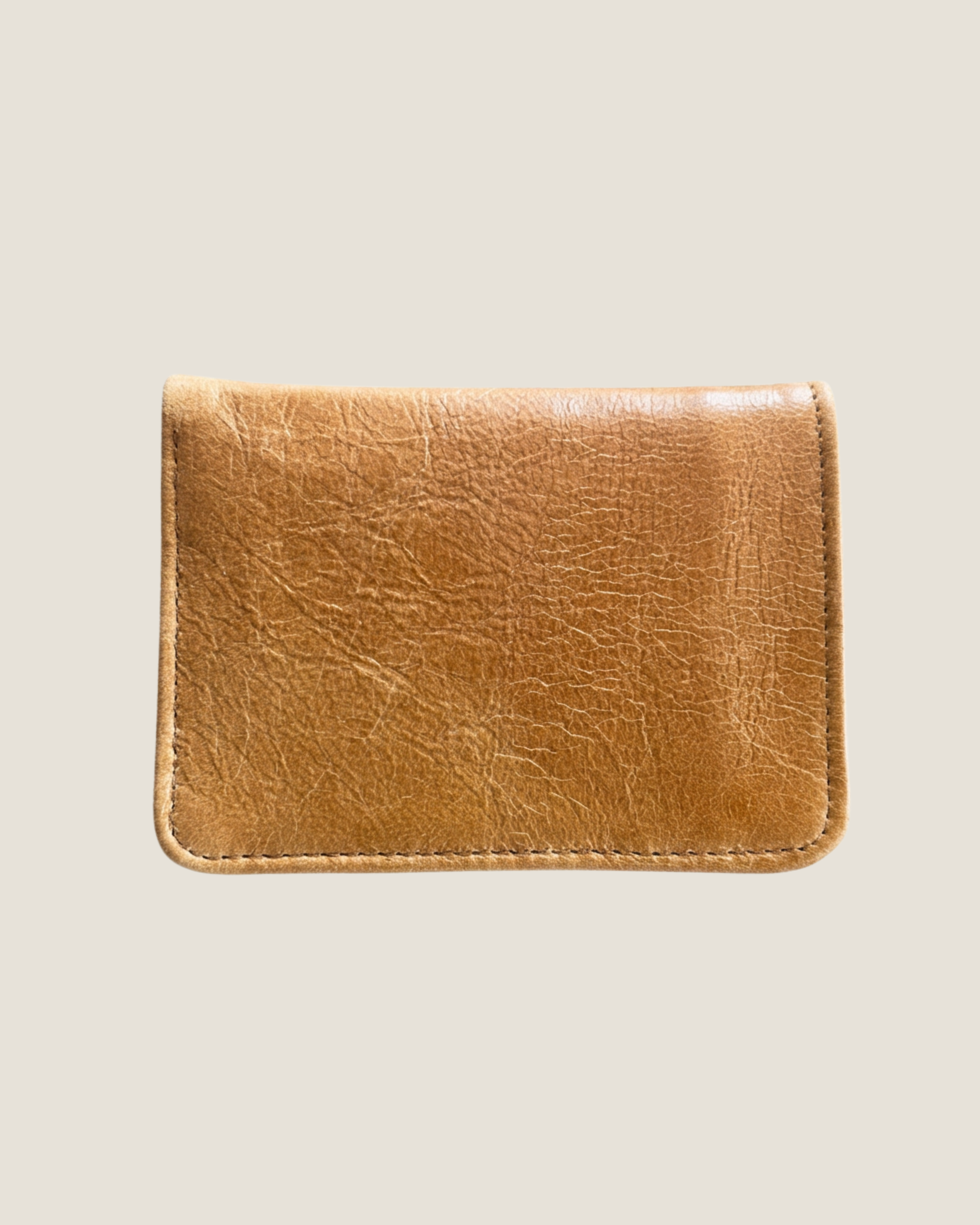 A genuine LEATHER WALLET by The Workroom, with its character-rich creases, hand made, genuine tan leather