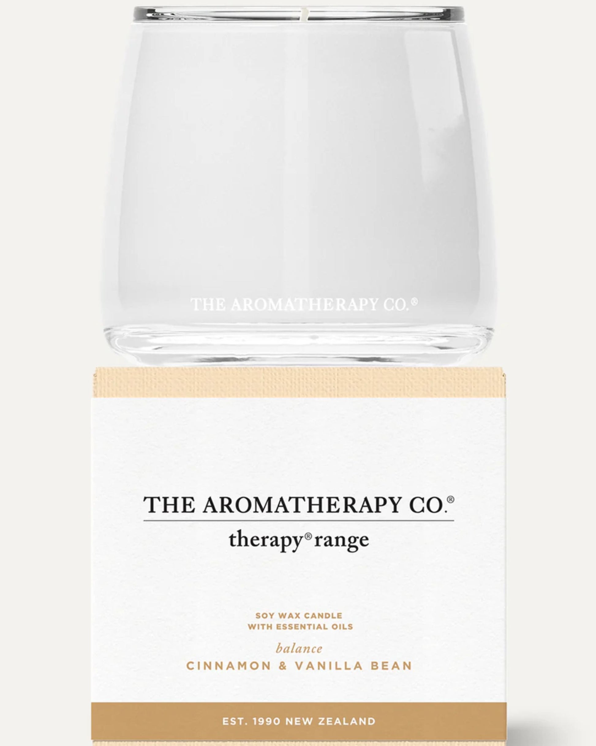 An AROMATHERAPY CANDLE by The Aromatherapy Co is crafted from premium soy wax and essential oils, housed in a clear glass jar. This candle features a harmonious blend of cinnamon and vanilla bean, encapsulated in sleek white and beige packaging. Established in New Zealand in 1990, this product is part of their therapy range.