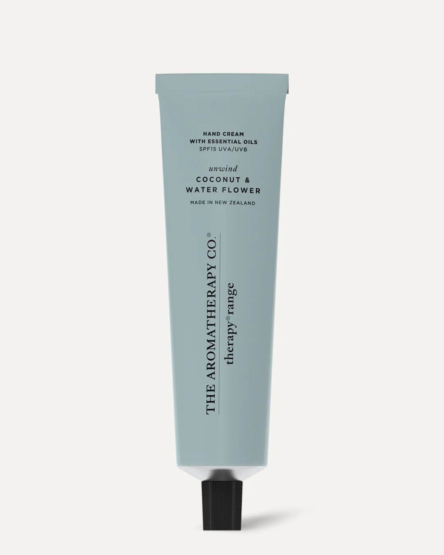 A light blue tube of AROMATHERAPY HAND CREAM from The Aromatherapy Co's therapy range is scented with coconut and water flower, infused with essential oils. Made in New Zealand, it features a black cap and a minimalist design.