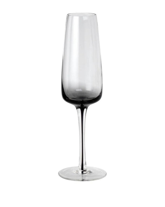 Introducing the CHAMPAGNE GLASS by Broste: A tall and slender design with elegant curves and a long stem, exuding timeless sophistication. Crafted from clear Broste glassware, it is photographed against a plain white background.