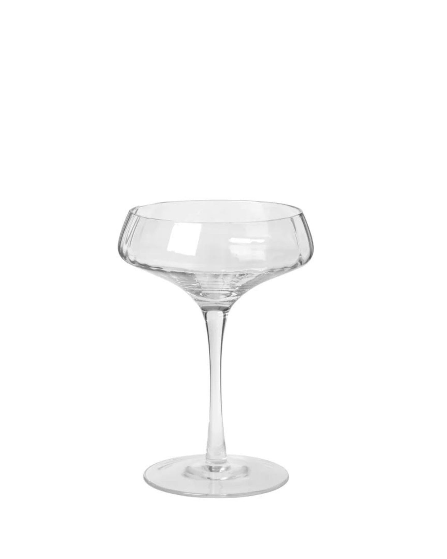 The Sandvig Cocktail Glass from Broste, featuring a wide rim, short stem, and flat base, epitomizes Nordic design against a white backdrop.