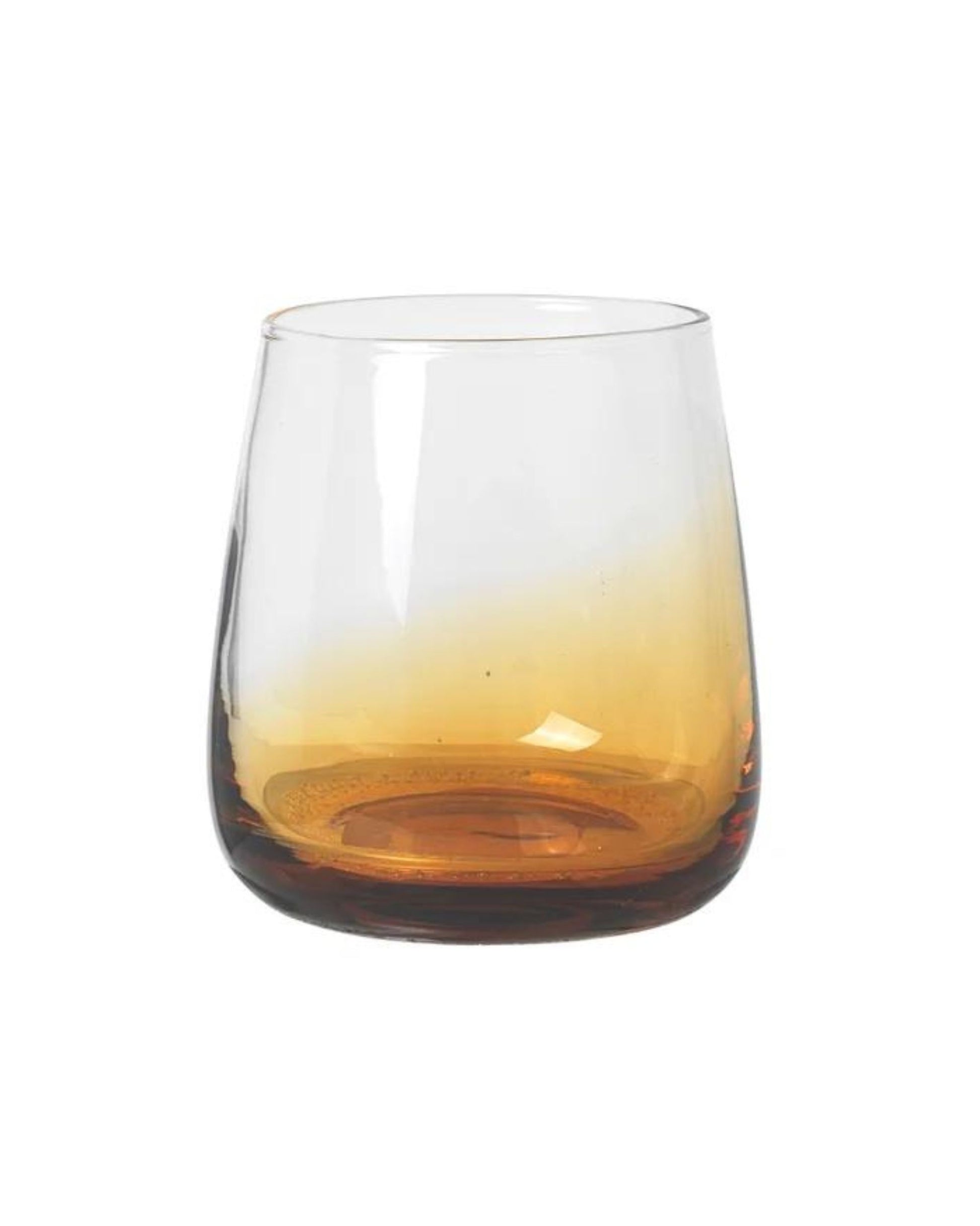 The SHORT TUMBLER from Broste features a rounded design with an amber gradient at the base that transitions to clear at the top, perfectly embodying Nordic nature against a plain white background for a touch of pure luxury.