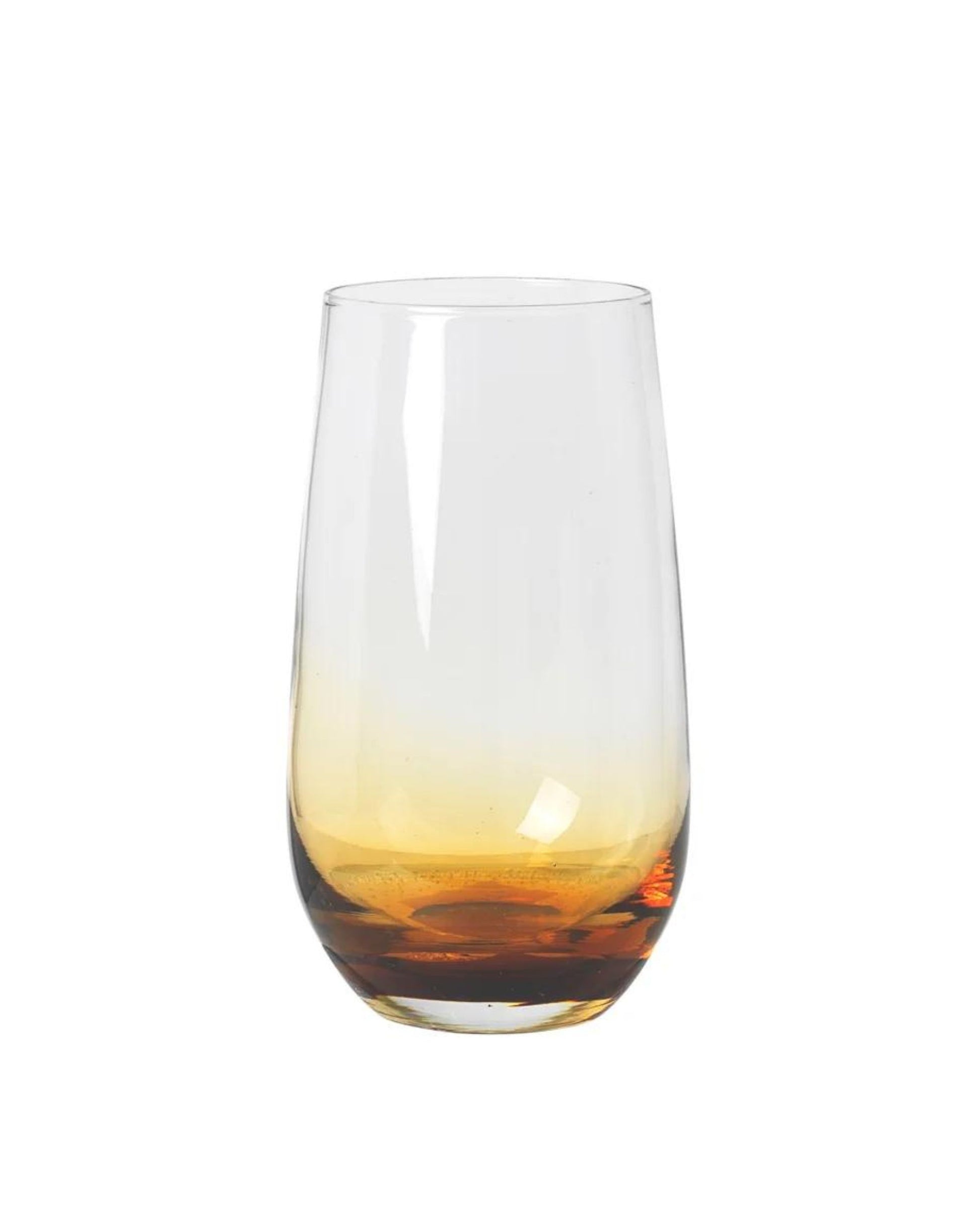 The TALL TUMBLER from Broste showcases a clear glass design with a gradient of warm amber tones at the base, seamlessly transitioning to transparent at the top. Its timeless sophistication is elegantly highlighted against a plain white background.