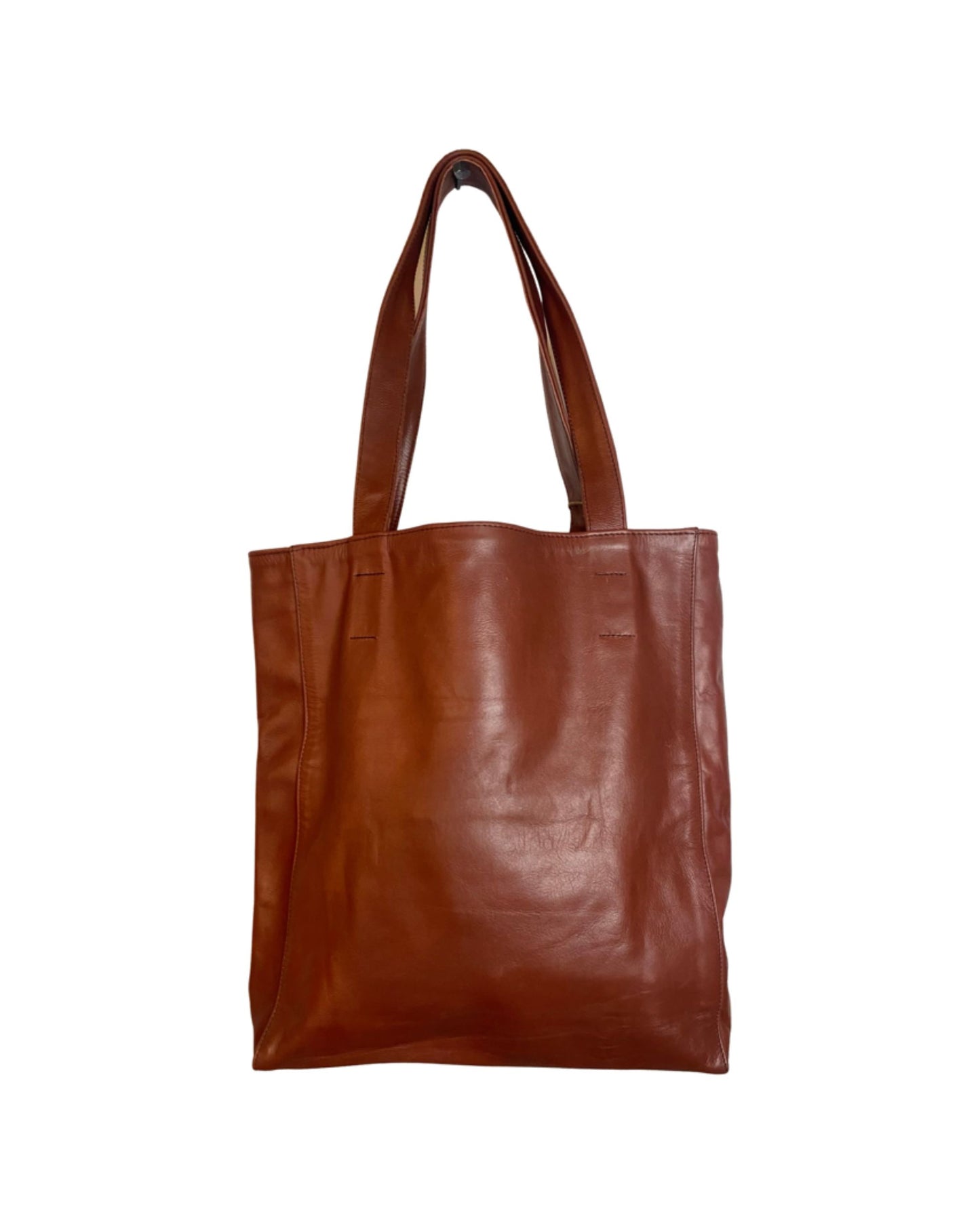 The CUIR LINED TOTE BAG from The Workroom features a stylish design with its soft leather, smooth texture, and elegant simplicity. Equipped with two sturdy handles, this brown leather tote enhances any outfit against a clean white background.