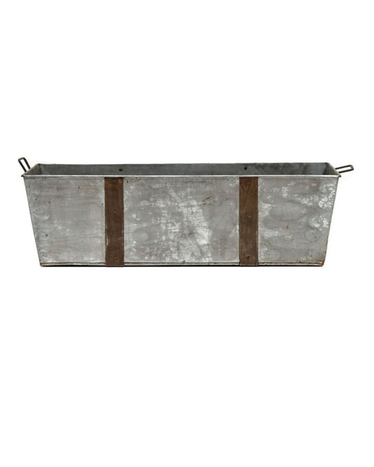 Introducing the FLINT RECTANGLE TUB by Hawthorne—a rectangular galvanized outdoor garden planter featuring two handles and two vertical wooden slats for support. Crafted from reclaimed iron, its weathered surface enhances its rustic appeal.