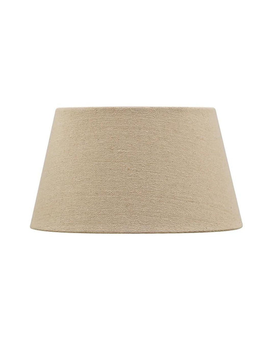 The FLAX BASKET WEAVE TAPERED DRUM 31CM LAMPSHADE by CC interiors is a beige fabric lampshade with a simple, cylindrical shape crafted from linen, set against a plain white background.