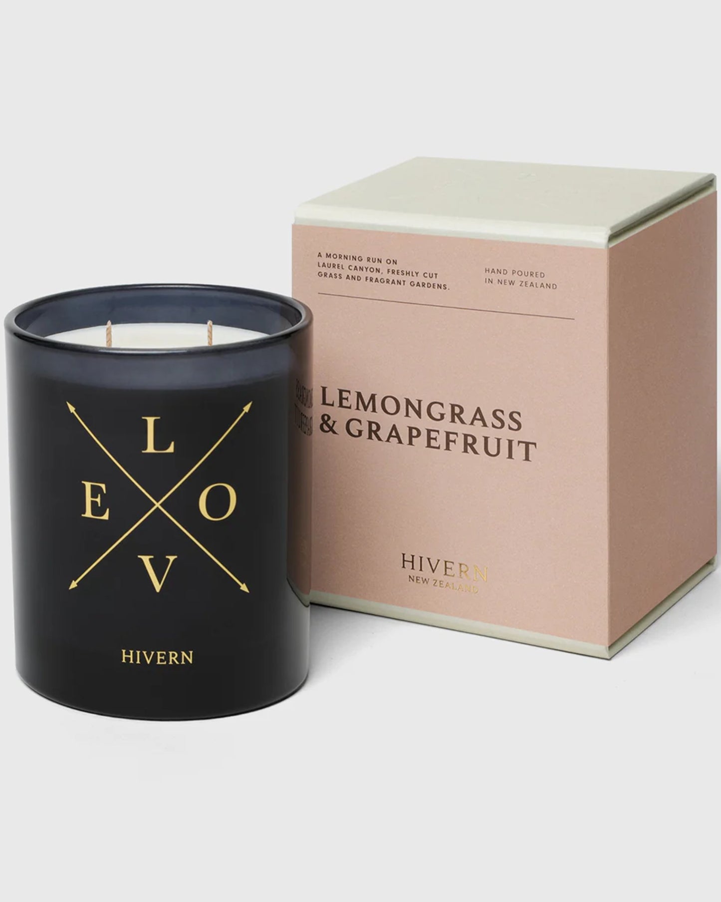 A black HIVERN CANDLE is displayed alongside a brown, square box labeled "Lemongrass & Grapefruit" by Hivern. This exquisite home fragrance from New Zealand, featuring gold lettering spelling LOVE and HIVERN on the candle, offers a burn-time of 55 hours and is hand-poured in New Zealand.