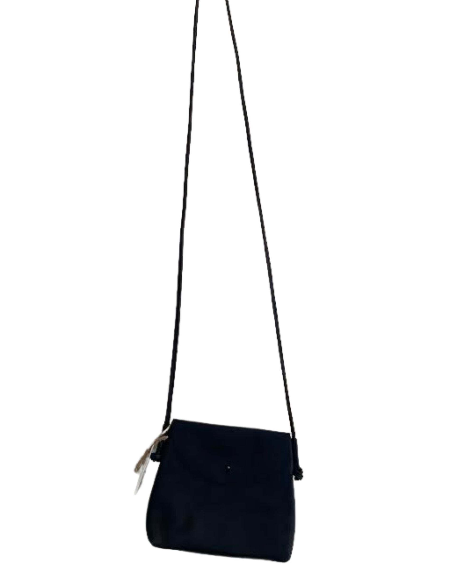 Image of the LEATHER KNOT PURSE by The Workroom, a minimalist black crossbody bag equipped with a long, slim strap. It showcases a small flap closure and features an attached tag on one side, made from full-grain leather for an elegant touch—making it a timeless statement accessory.