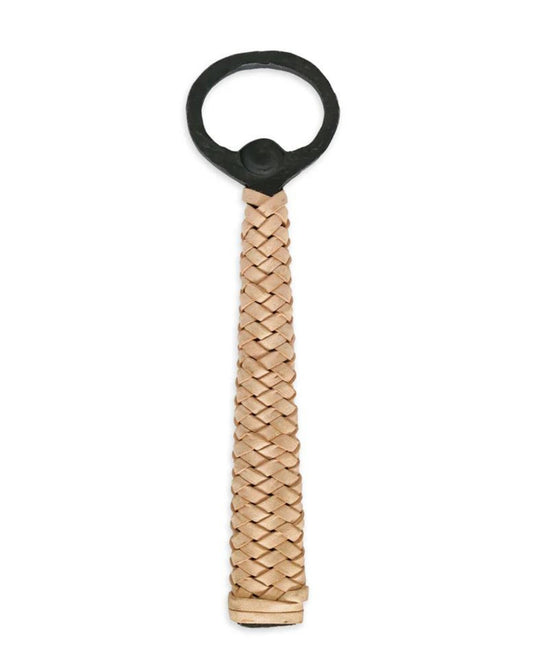 The LANDLUBBER BOTTLE OPENER by Society Ink boasts a sleek design with a round black metal top and a handle elegantly wrapped in tan braided leather, making it perfect for any occasion in Australia.