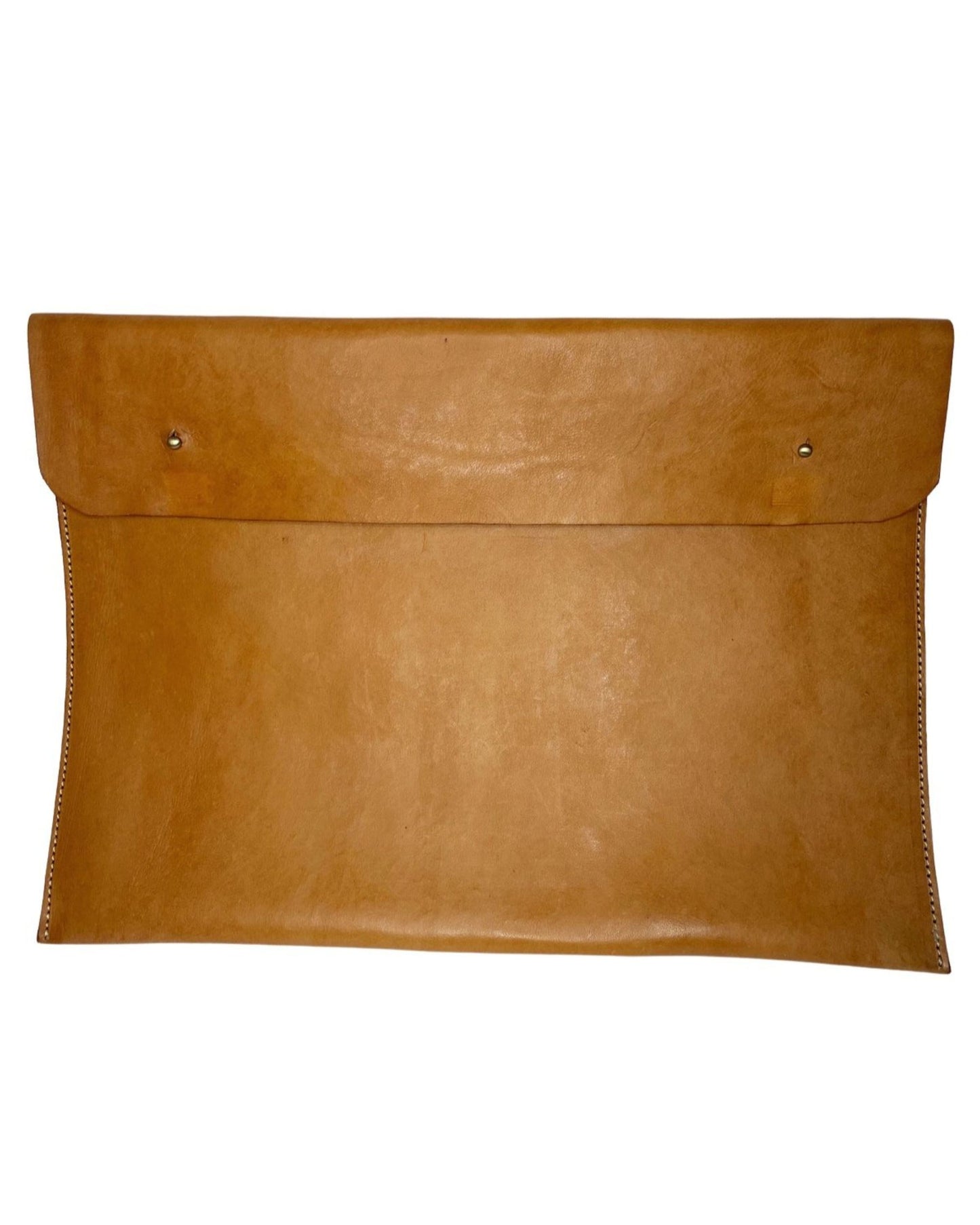 The elegant LEATHER LAPTOP COVER by The Workroom is a large brown envelope-style clutch crafted from 100% leather, featuring a smooth texture and two small metal studs on the front. Its visible stitching along the edges makes it perfect for use as a chic leather laptop case.