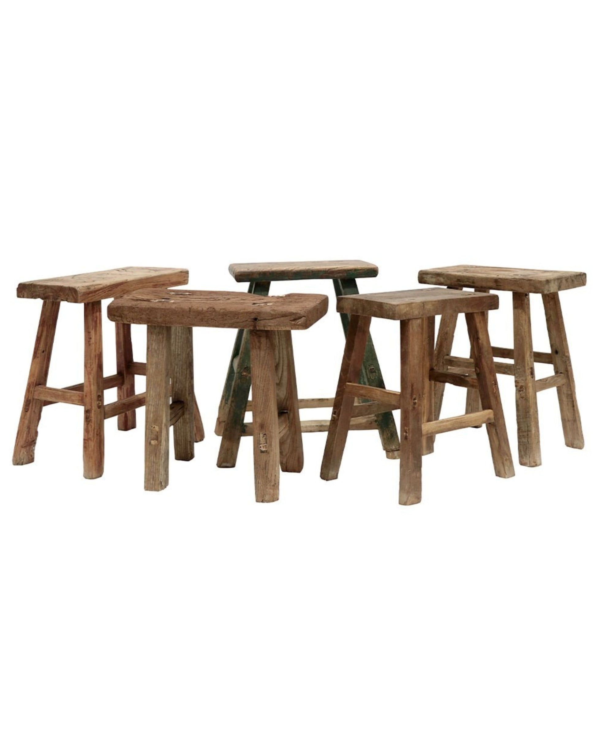 Five WOODEN RECTANGLE STOOLS from Hawthorne, arranged in a semi-circle, each featuring a simple and sturdy design. The stools' natural, weathered finish enhances the unique grain patterns and textures, reminiscent of traditional craftsmanship from Shandong Province.