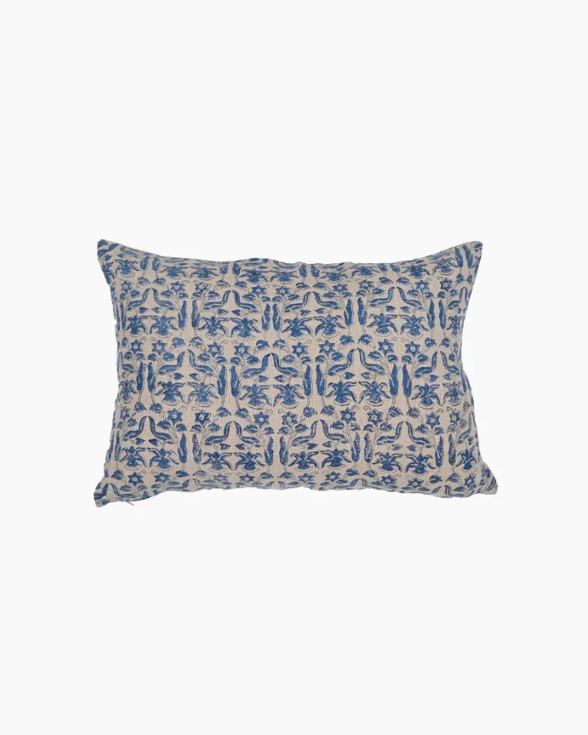 Introducing the PETRO FLORAL AZURE CUSHION COVER: a rectangular cushion cover adorned with a blue floral print on a white background, ideal for enhancing your home decor. Its soft linen cover displays an array of leaf and flower motifs arranged symmetrically.