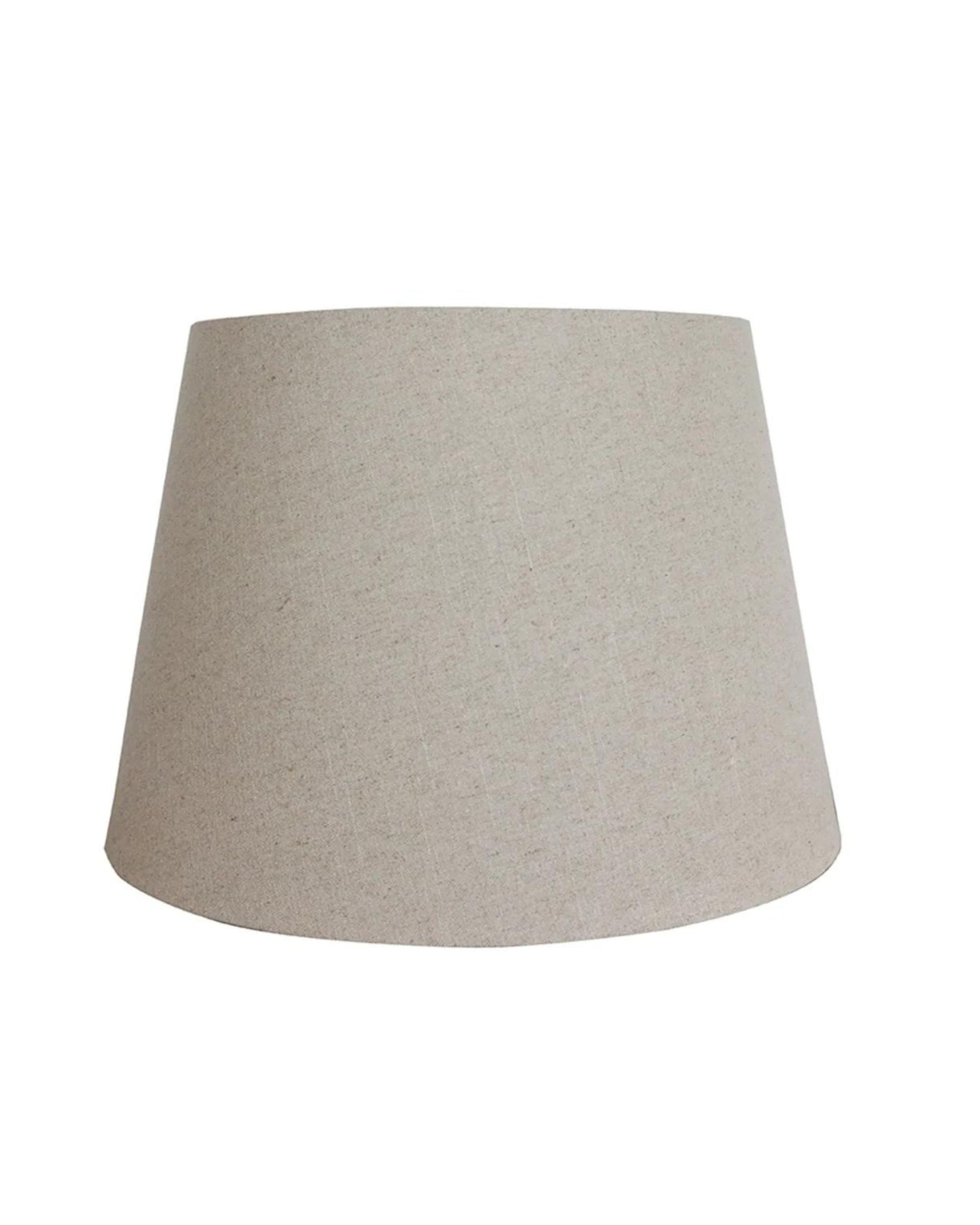 The RAW LINEN TALL DRUM 46CM LAMPSHADE by CC Interiors boasts a beige, conical shape with a textured fabric surface that enhances the elegance of any room. Its minimalist design, free from visible patterns or decorations, makes it a versatile home décor piece that effortlessly complements various styles.