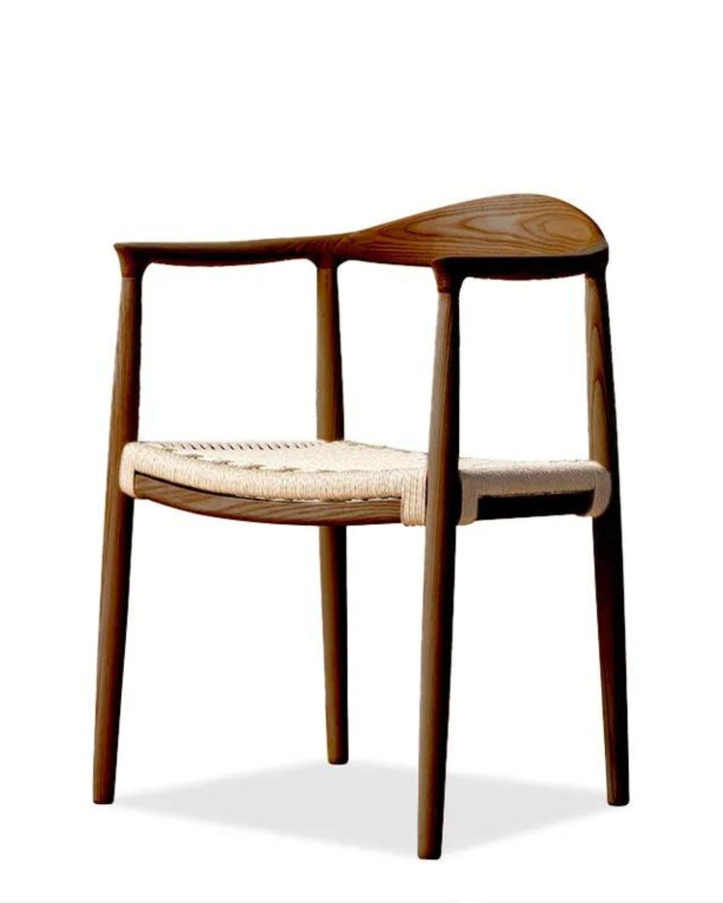 The RYDER CHAIR by Capulet emphasizes minimalist design with its wooden armchair structure, curved backrest, and woven seat. It features smooth, rounded arms and legs made from North American ash, providing comfortable seating with a natural wood finish. The seat is crafted from a light-colored natural woven rope material.