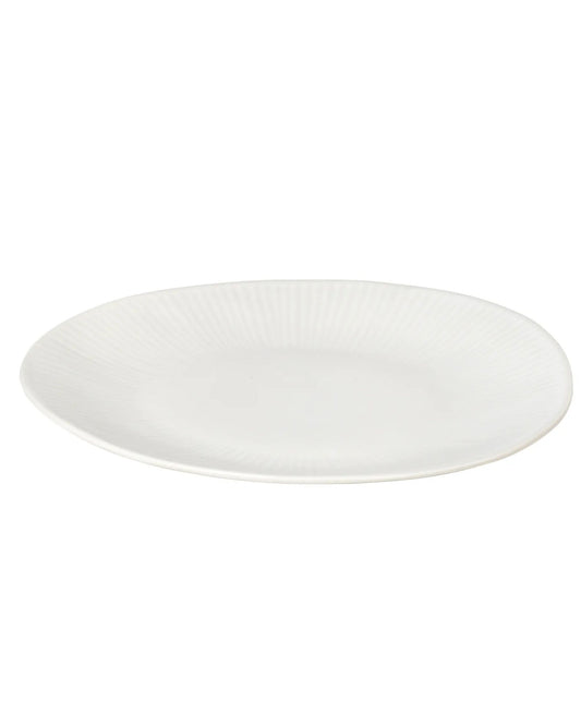 The SANDVIG DESERT/LUNCH PLATE by Maytime, viewed from an angle, displays a subtle ribbed texture around its edges. Set against a white background, it exemplifies the simplicity and coastal charm characteristic of Broste Copenhagen designs.