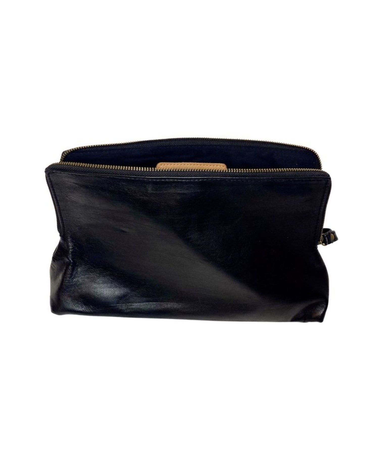 The LEATHER ZIP COSMETIC BAG by The Workroom features a black full-grain leather exterior complemented by a brown interior, open to reveal its soft and smooth texture. This pouch is ideal for organizing your beauty routine and exudes elegance and style against a plain white background.